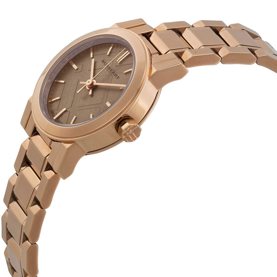 Side view of Burberry The City Petite watch showing rose gold case and link bracelet