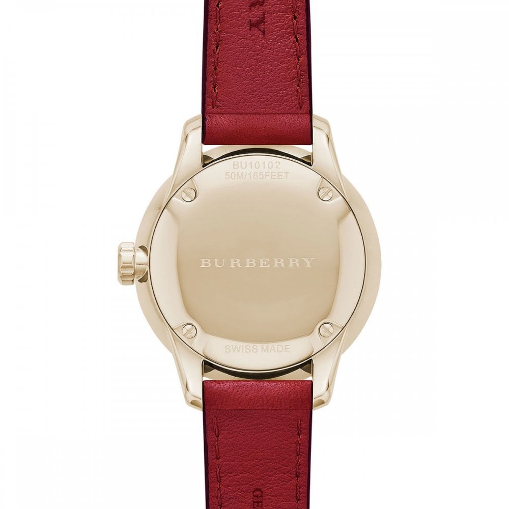 Burberry The Classic watch caseback showing gold-tone stainless steel case and burgundy leather strap