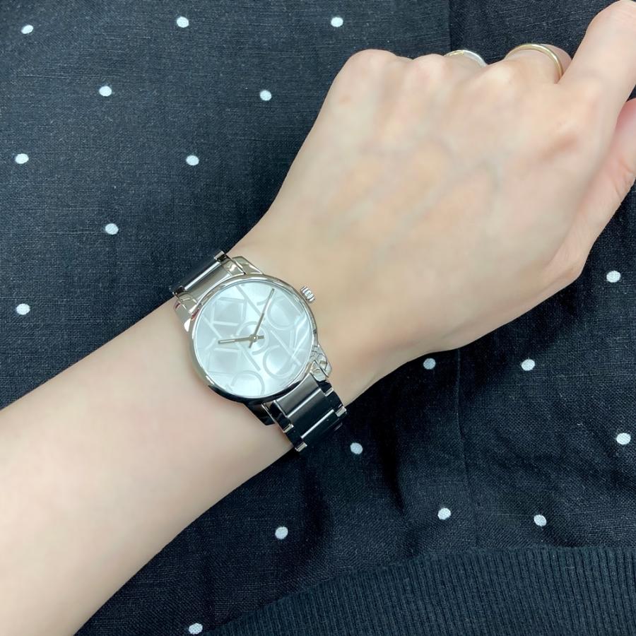 Calvin Klein City watch with silver dial worn on woman's wrist
