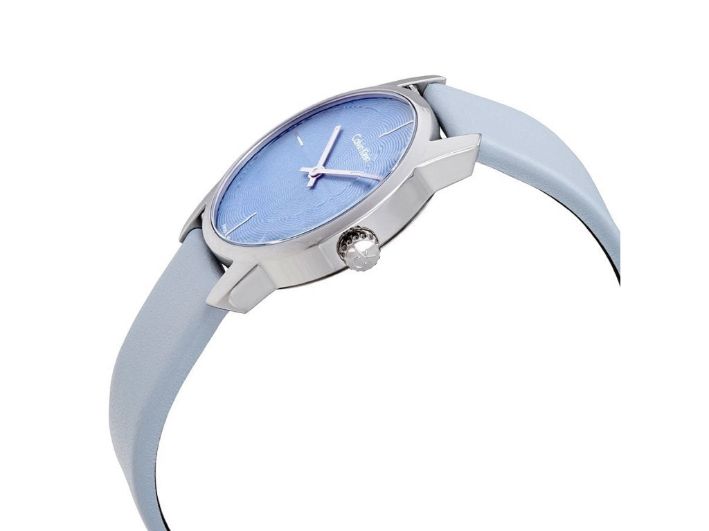 Calvin Klein City women's watch worn on wrist with blue dial and leather strap