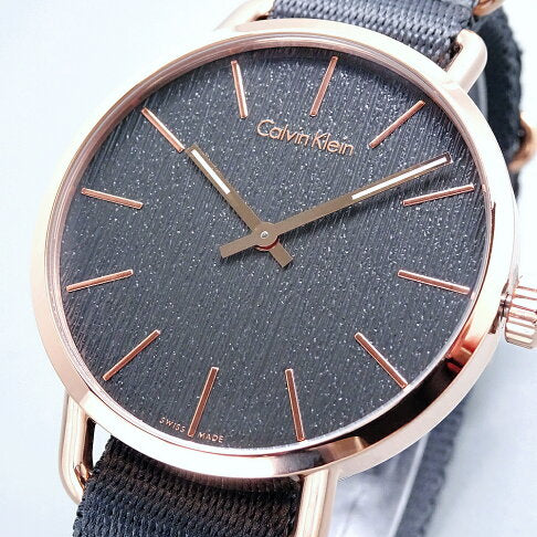 Calvin Klein Even dial close-up showing grey textured surface and rose gold index markers