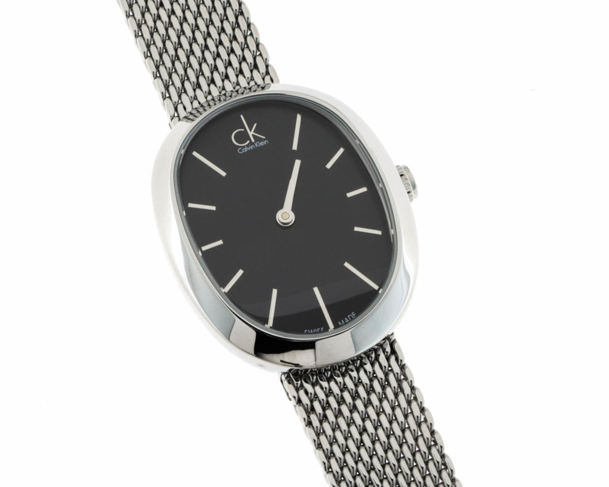 Top-down view of Calvin Klein Incentive watch with black dial and silver mesh band