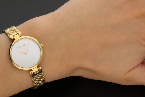 Calvin Klein rose gold watch on wrist showing mesh band detail