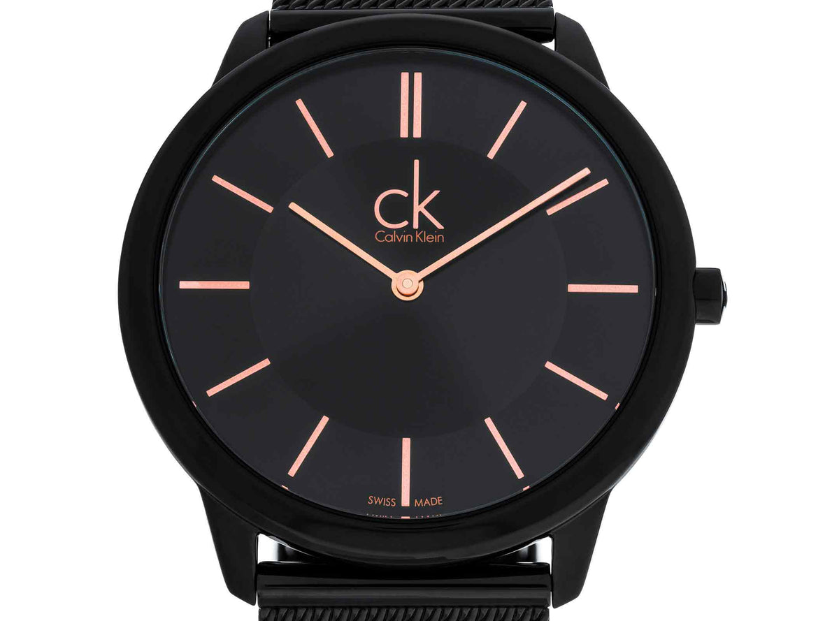 Close-up of black dial with rose gold hour markers and ck logo