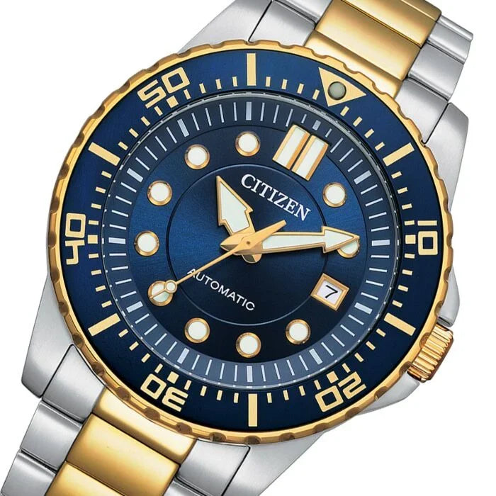 Close-up of blue dial with applied hour markers, date window, and gold-tone hands
