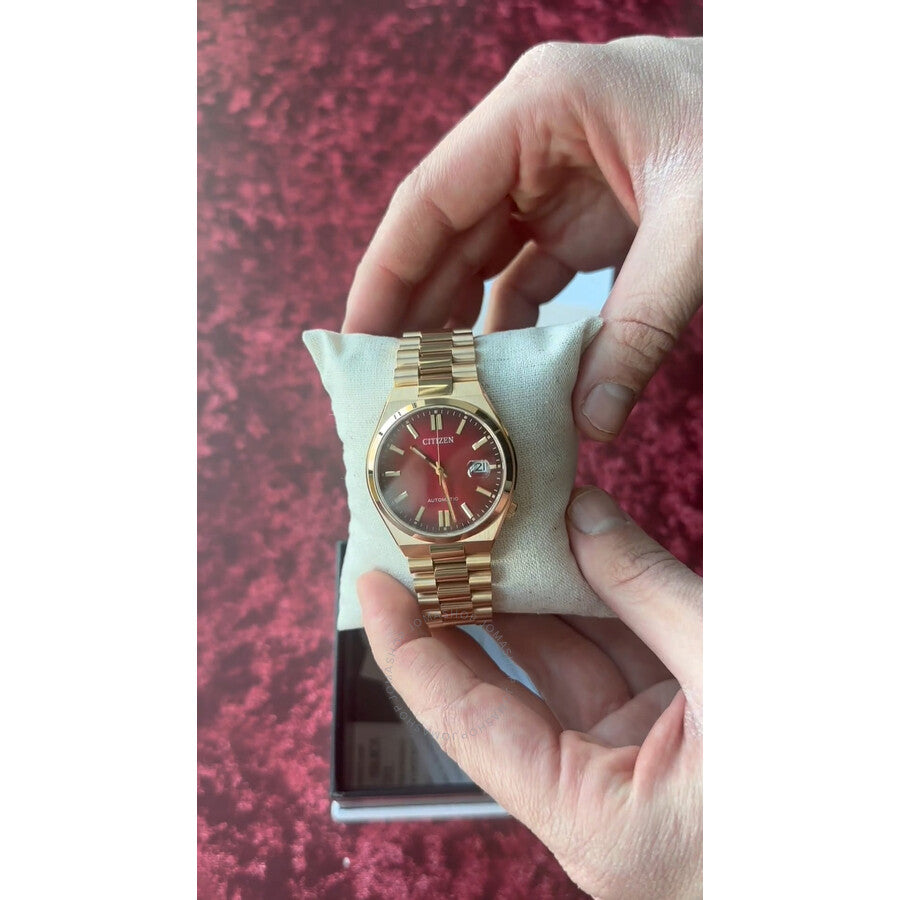 Citizen Tsuyosa automatic watch on wrist showing red dial and gold-tone stainless steel design