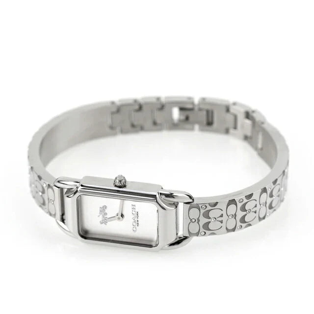 Coach women's watch with Heritage logo dial worn on wrist, stainless steel bracelet