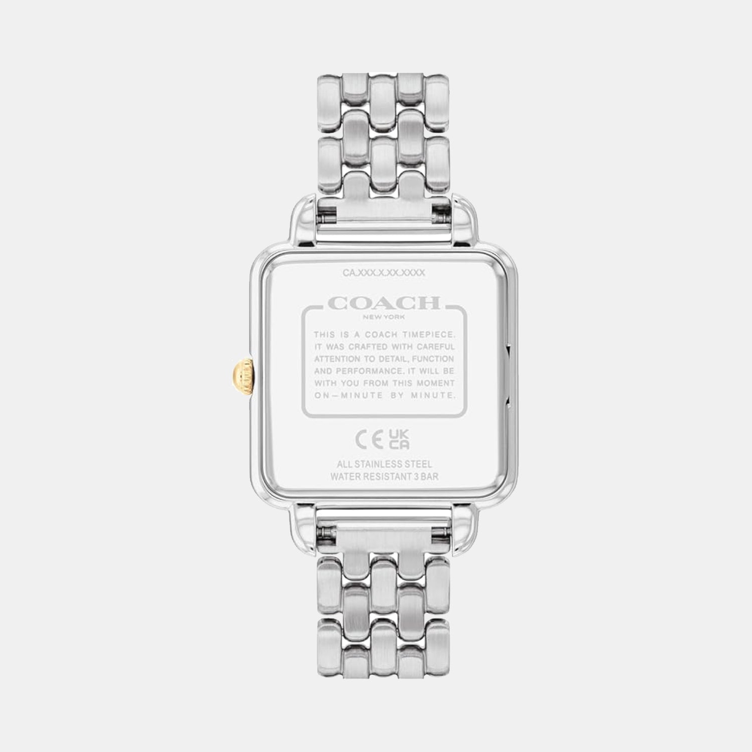 Coach watch caseback showing stainless steel case with engraved branding and specifications