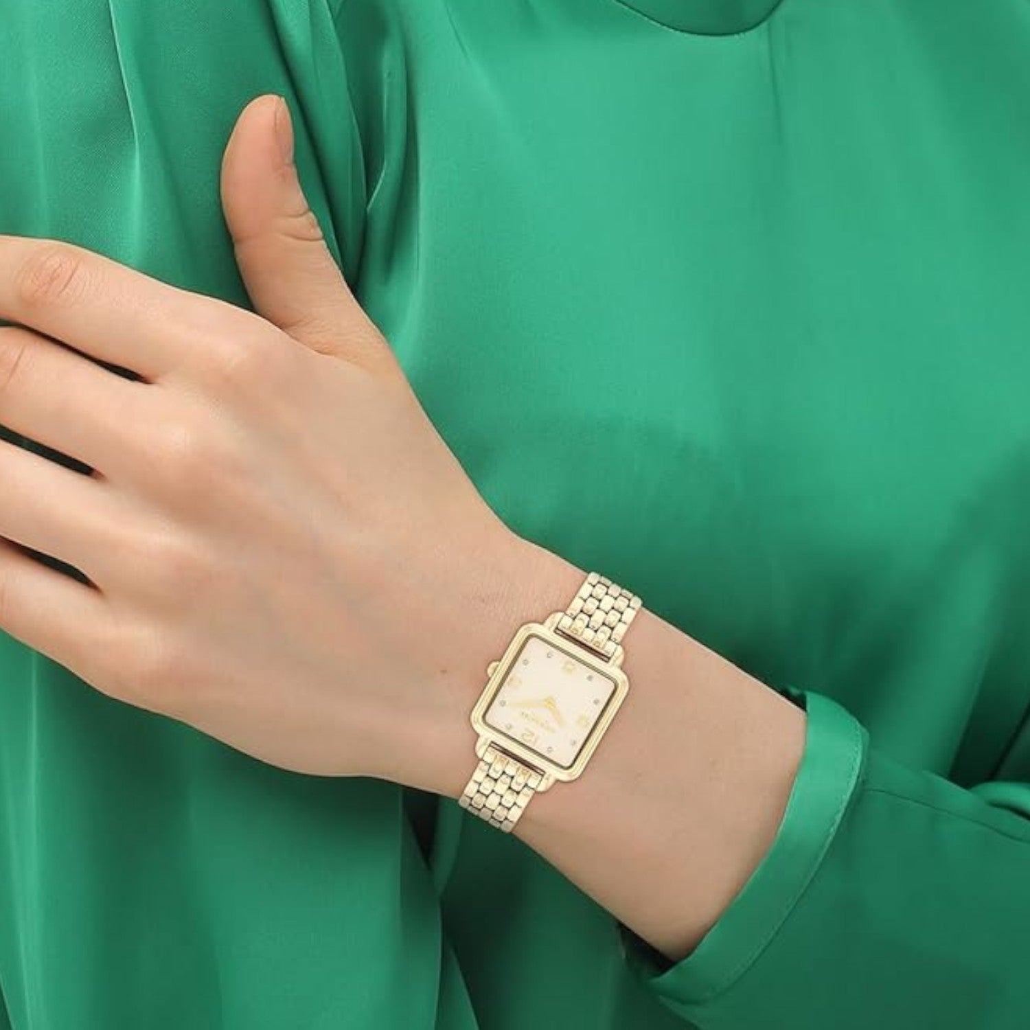 Coach Cass watch worn on wrist showing champagne dial and gold-tone link bracelet