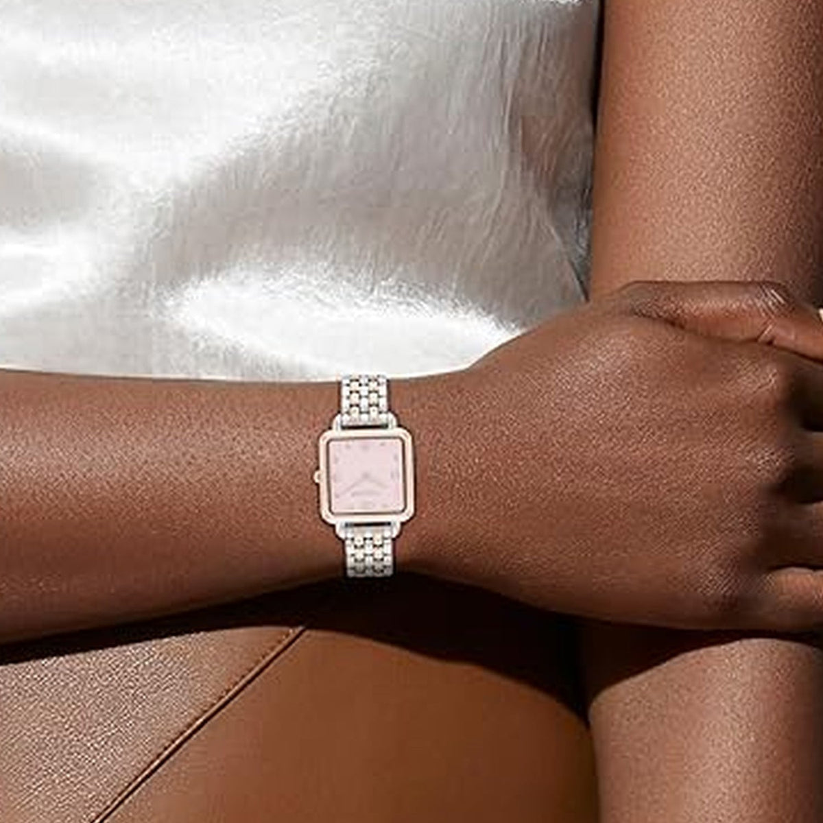 Coach Cass pink dial watch worn on wrist with stainless steel bracelet