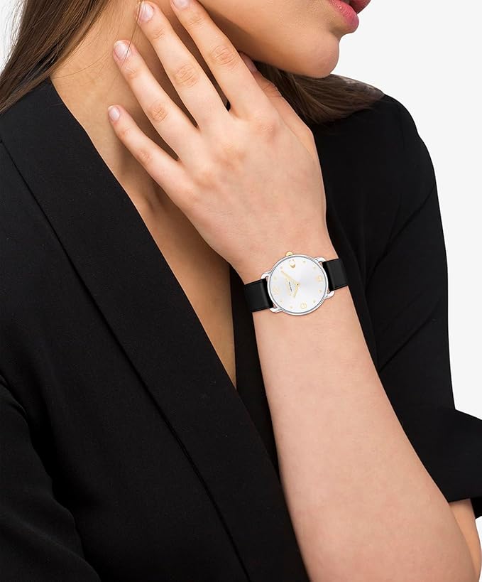 Coach Elliot womens watch worn on wrist with black leather strap and white dial
