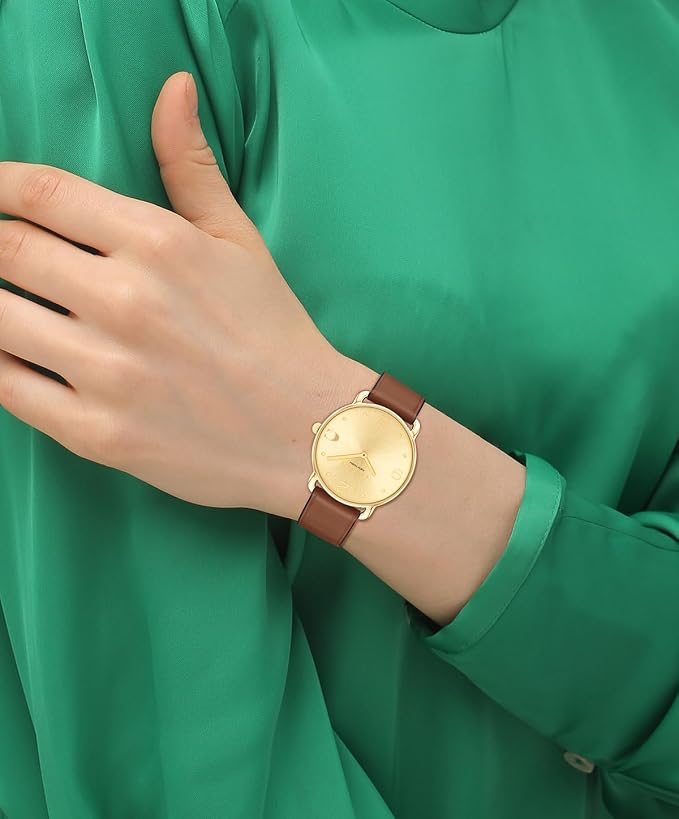 Coach Elliot 36mm watch worn on wrist with gold case and brown leather strap