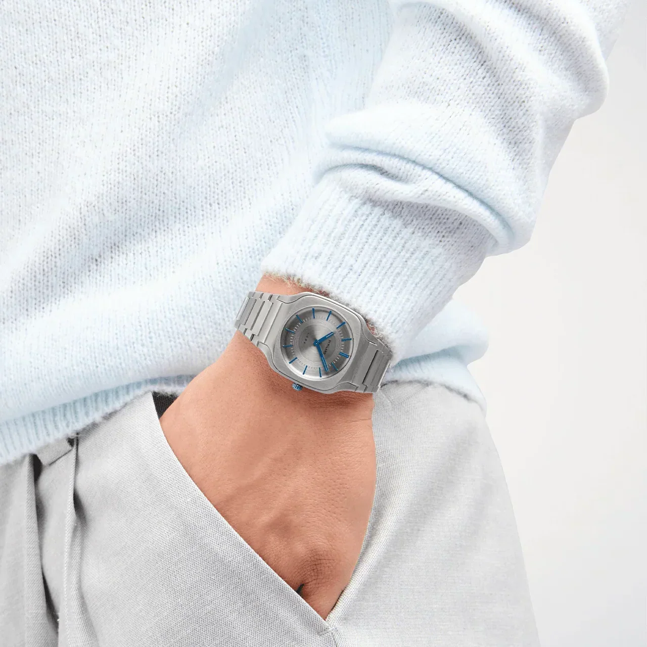 D1 Milano SQBJ02 titanium watch on wrist over light sweater