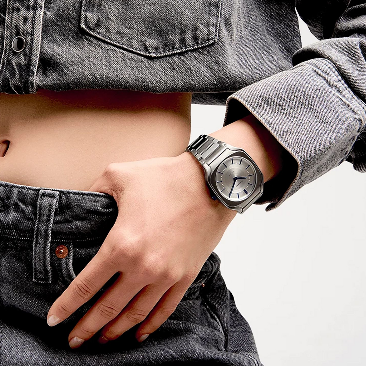 D1 Milano Square titanium watch worn on wrist with denim and sweater