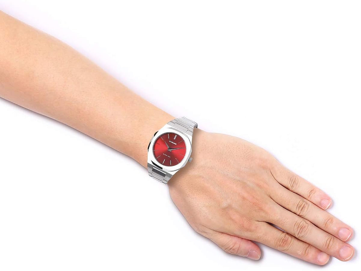 D1 Milano Ultra Thin watch on wrist, displaying ruby red dial and stainless steel bracelet