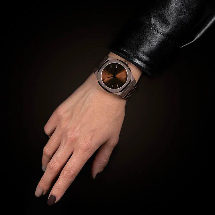 D1 Milano UTBJ10 rose gold watch on wrist against dark background