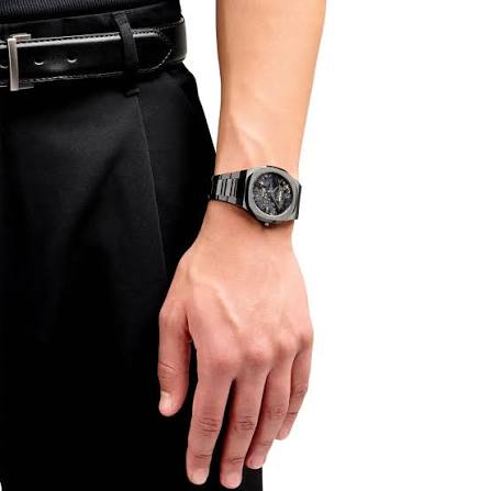 D1 Milano Ultra Thin UTBJ31 black watch worn on wrist with formal attire