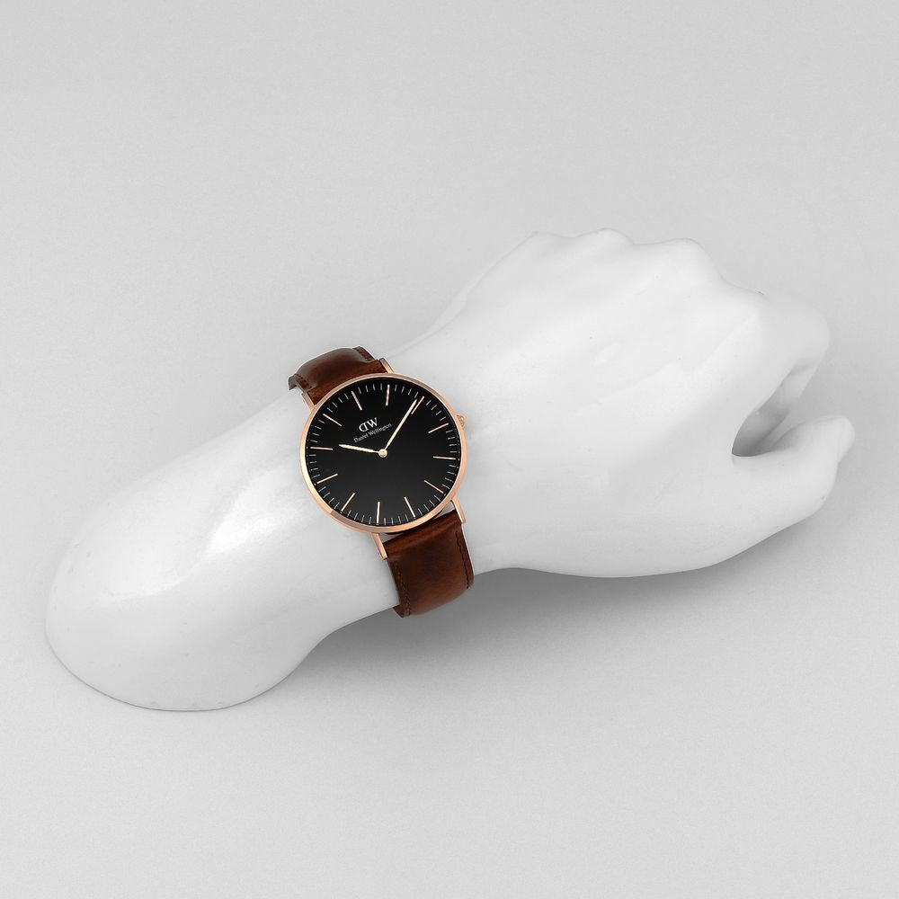 Daniel Wellington Bristol 40mm men's gold watch worn on wrist with brown leather strap