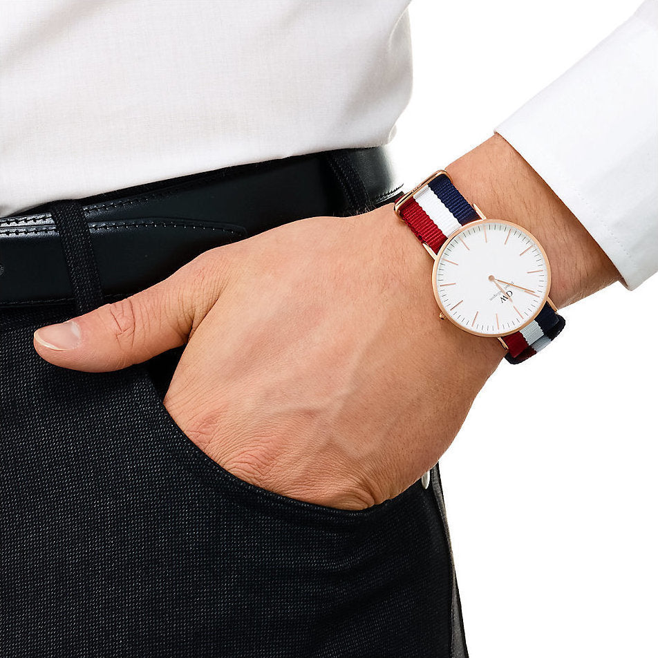 Daniel Wellington Cambridge 40mm gold watch worn on wrist with tricolour NATO strap