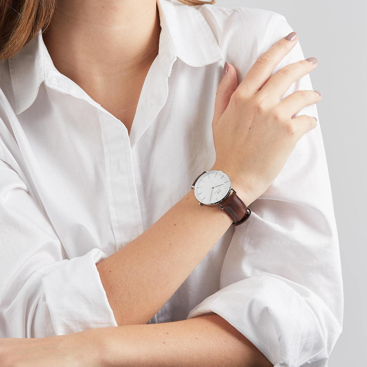 Daniel Wellington Classic Bristol 36mm worn on wrist with white dial and brown leather band