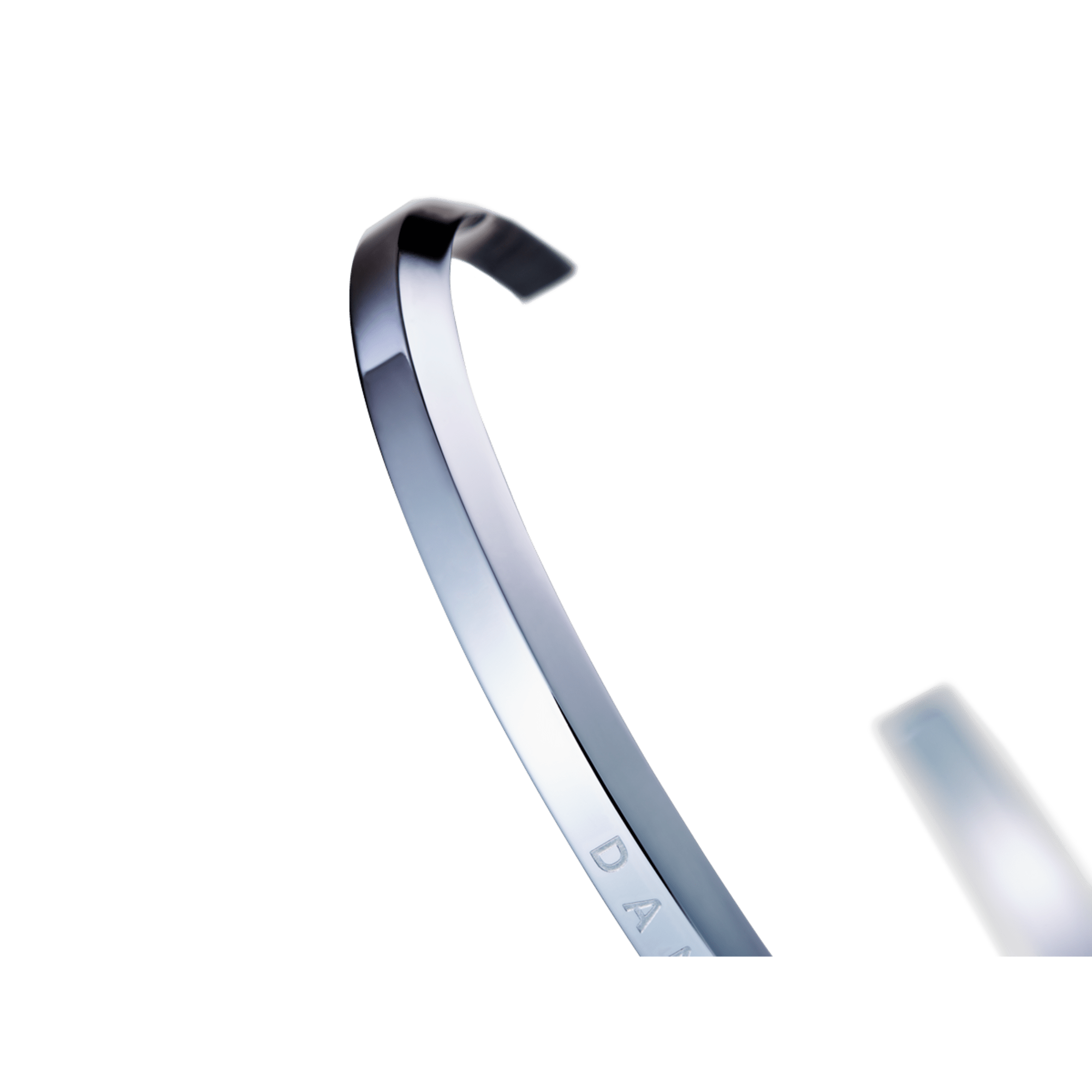 Side view of silver cuff bracelet showing curved profile and inner engraving