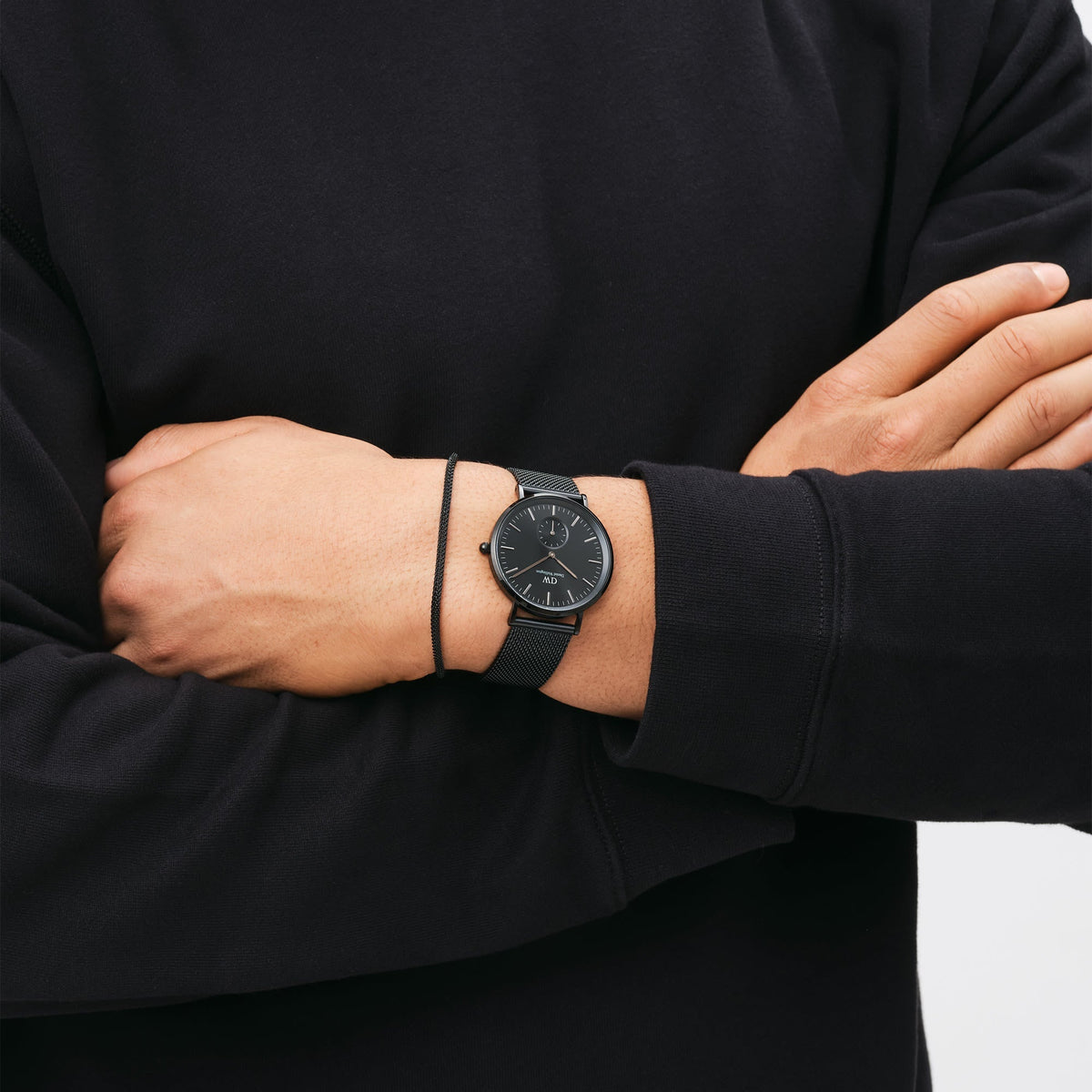 Daniel Wellington Ashfield Onyx watch worn on wrist with black mesh band