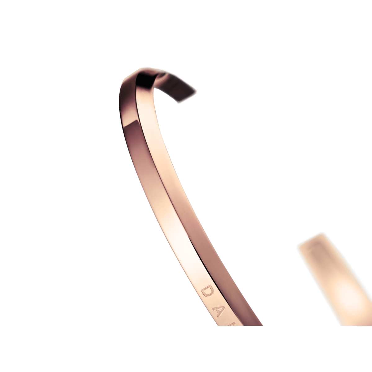 Daniel Wellington rose gold cuff angled view showing curved shape and engraving detail