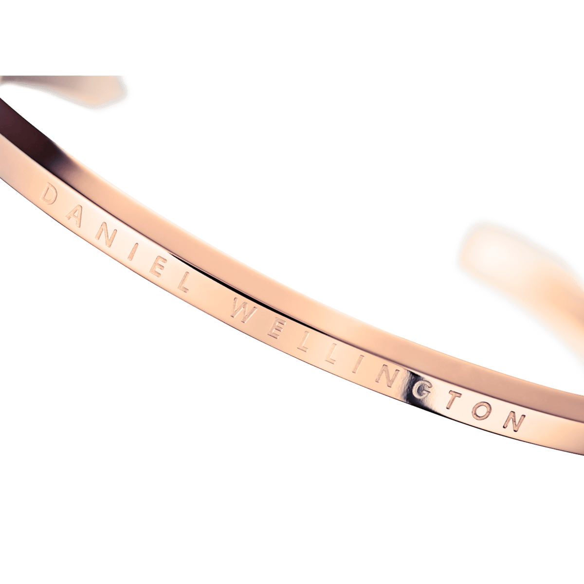 Daniel Wellington rose gold cuff close-up of engraved logo detail on interior