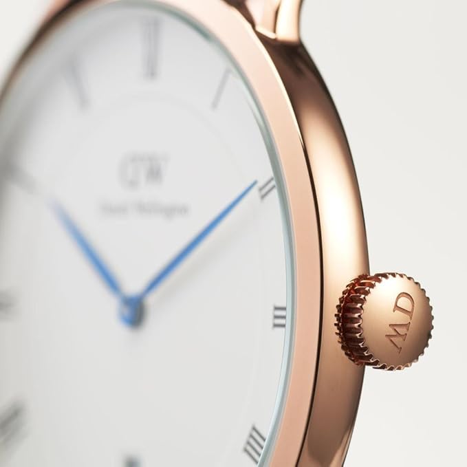 Close-up of watch dial with Roman numerals, Daniel Wellington branding, and crown detail