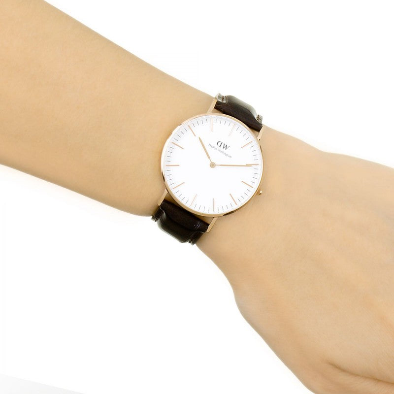 Daniel Wellington Classic York 36mm watch on wrist showing white dial face and brown leather band