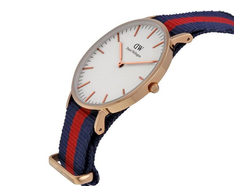 Side angle view of DW Oxford 36mm watch showing gold case and striped NATO strap