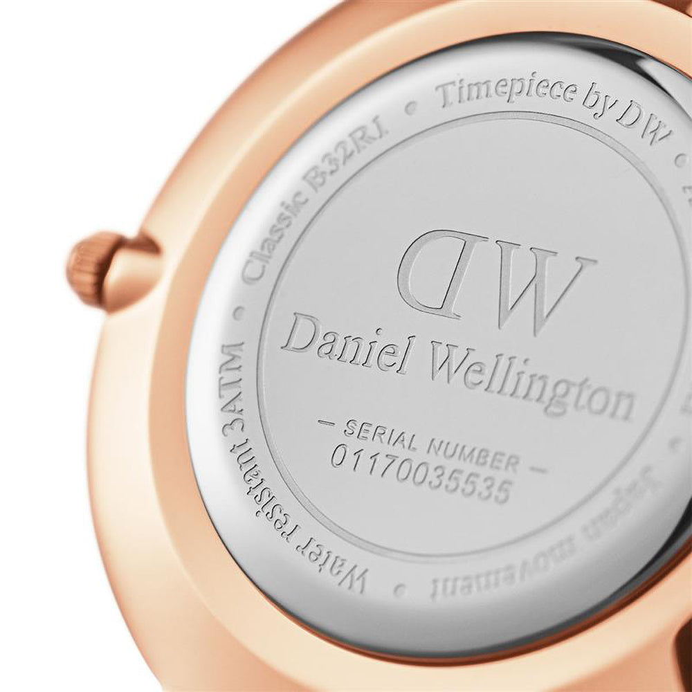 Detailed view of Daniel Wellington branding and white dial with rose gold hour markers