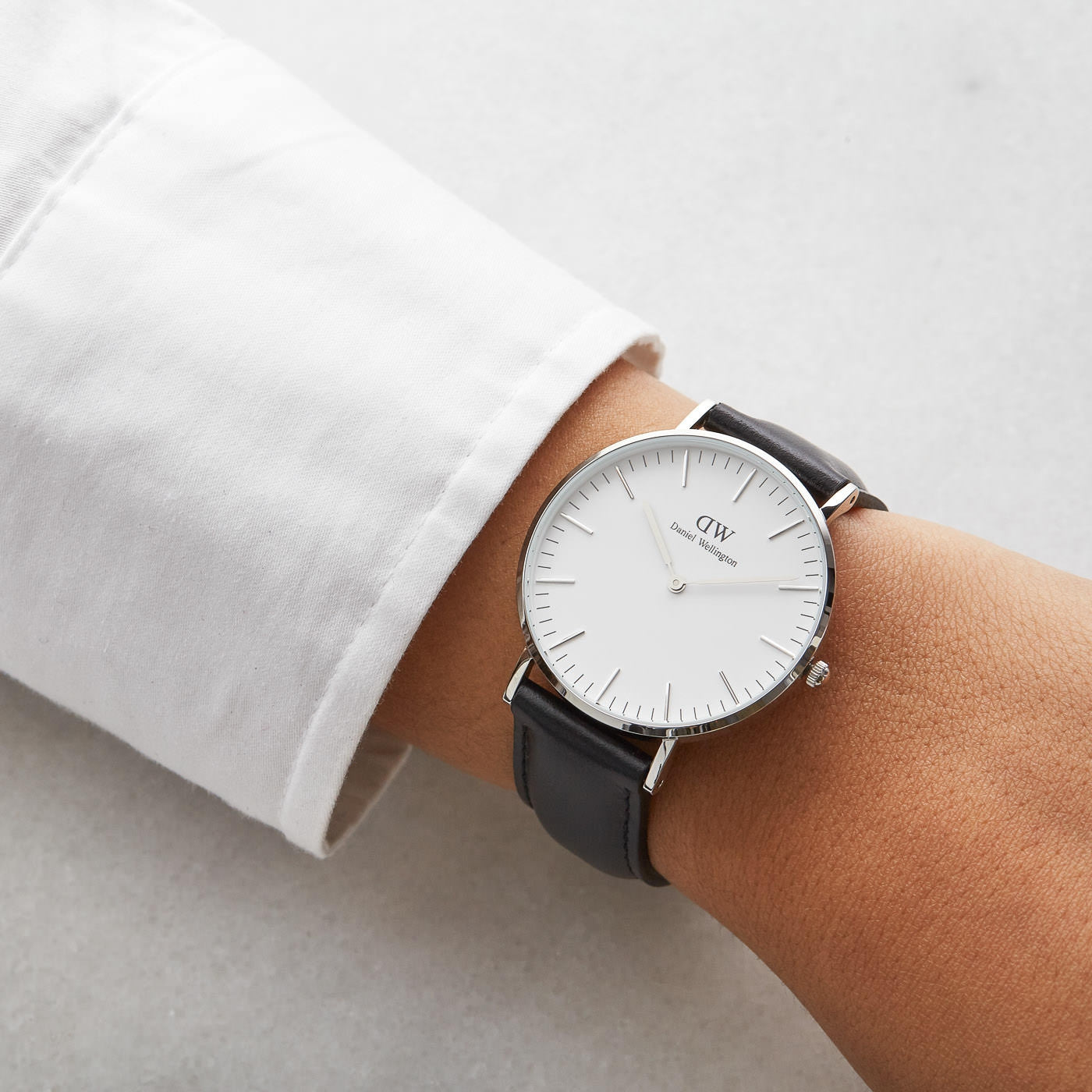 Daniel Wellington Sheffield 36mm watch worn on wrist with white dial and black leather strap