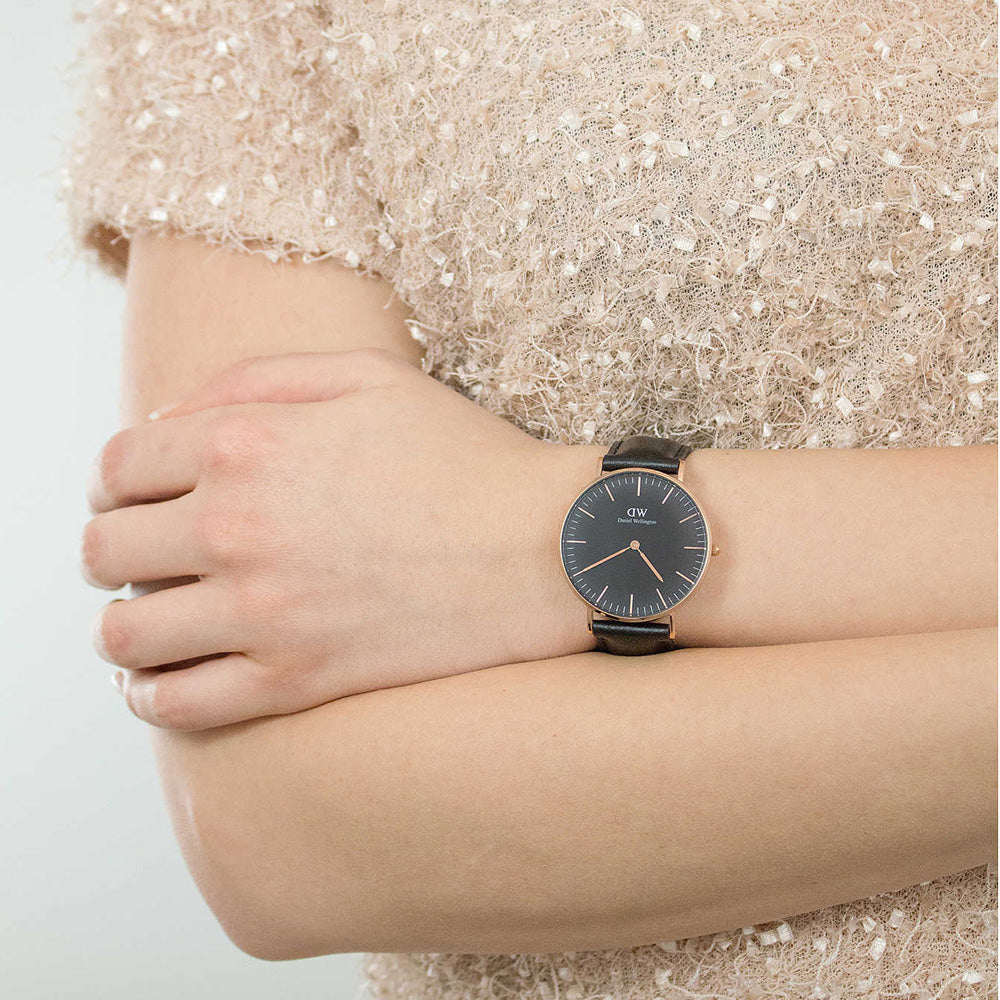 Daniel Wellington Sheffield 36mm watch worn on wrist with black dial and gold case