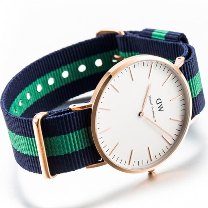 Angled view of Warwick 40mm watch with white dial and navy blue-green striped strap detail