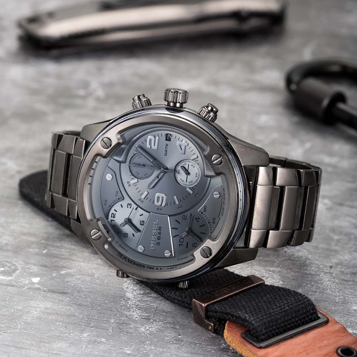 Diesel Boltdown DZ7426 gunmetal watch displayed at angle with metal links