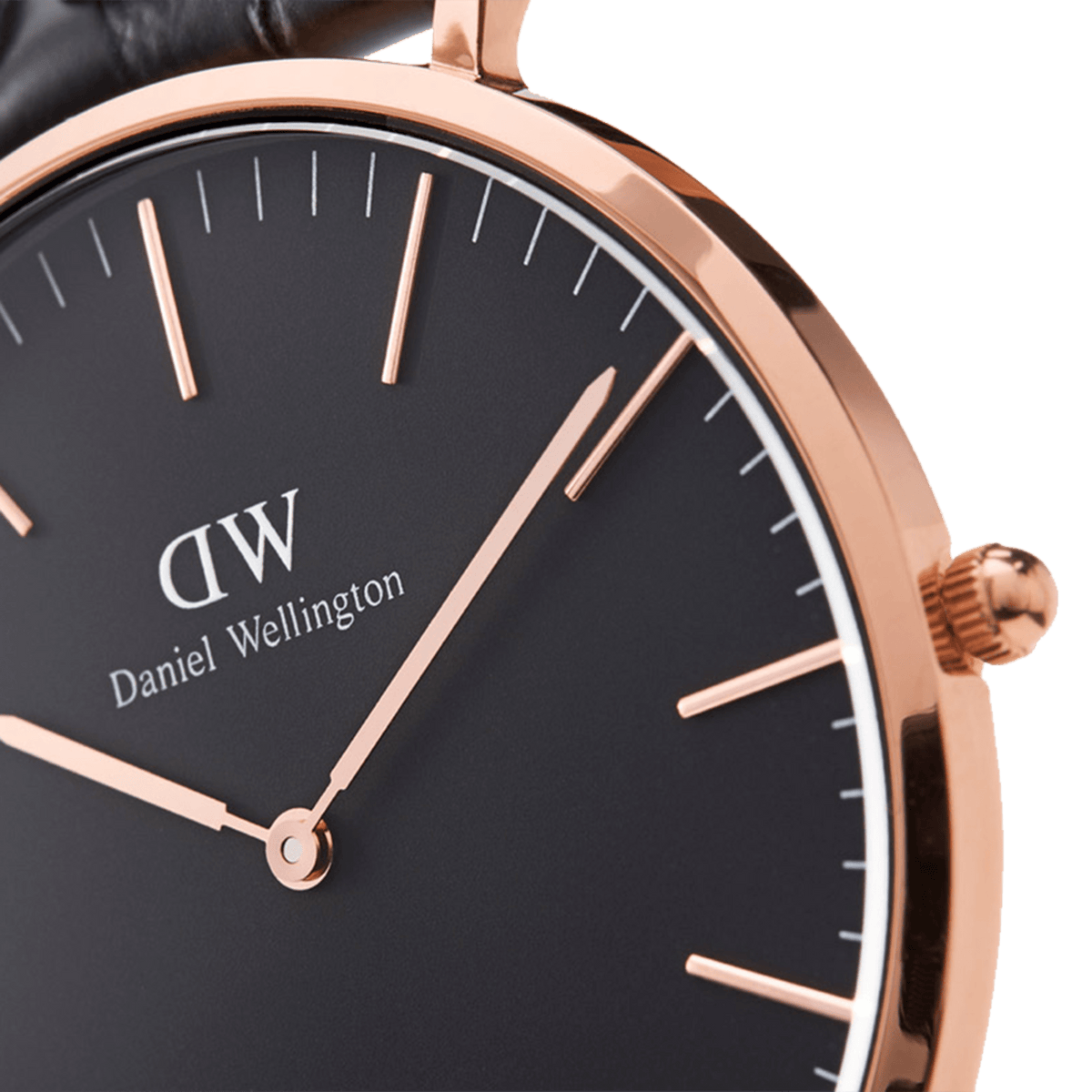 Close-up of black dial featuring DW logo, Daniel Wellington text, rose gold hour markers and hands