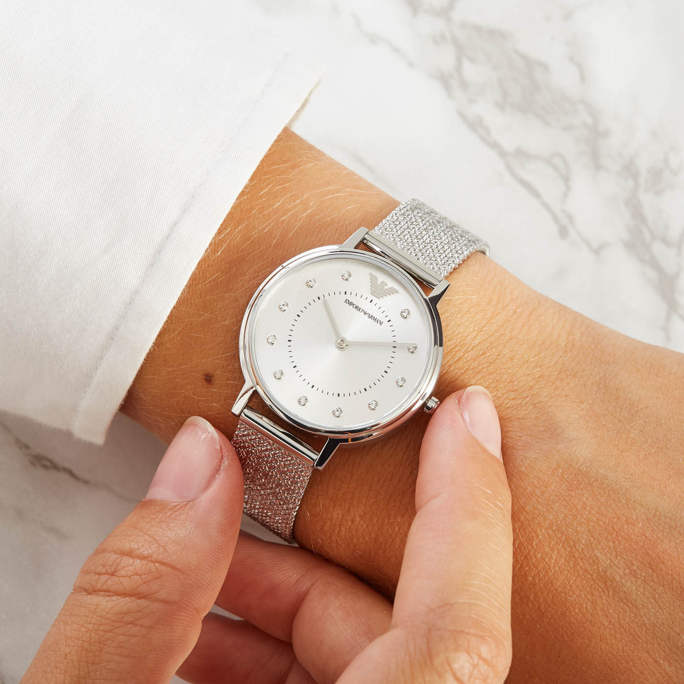 Emporio Armani AR11128 watch worn on wrist with silver mesh bracelet