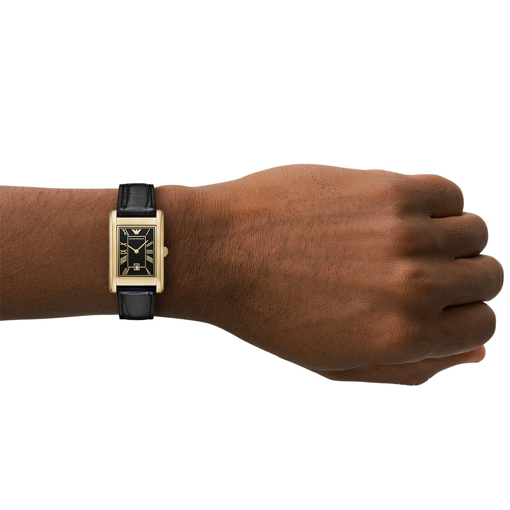 Emporio Armani Gino watch worn on wrist showing gold rectangular case and black leather strap