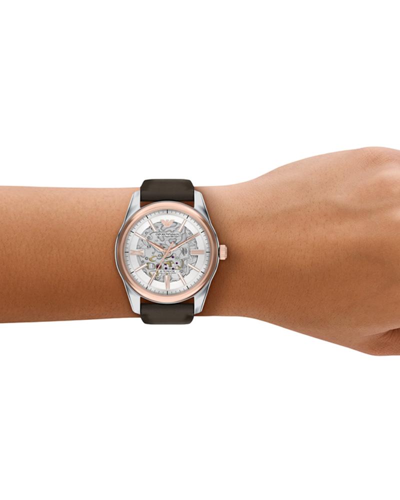 Emporio Armani AR60094 automatic watch worn on wrist showing skeleton dial and two-tone case