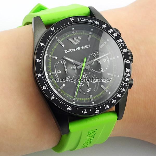 Emporio Armani AR6115 watch worn on wrist displaying black dial with green accents and green rubber strap