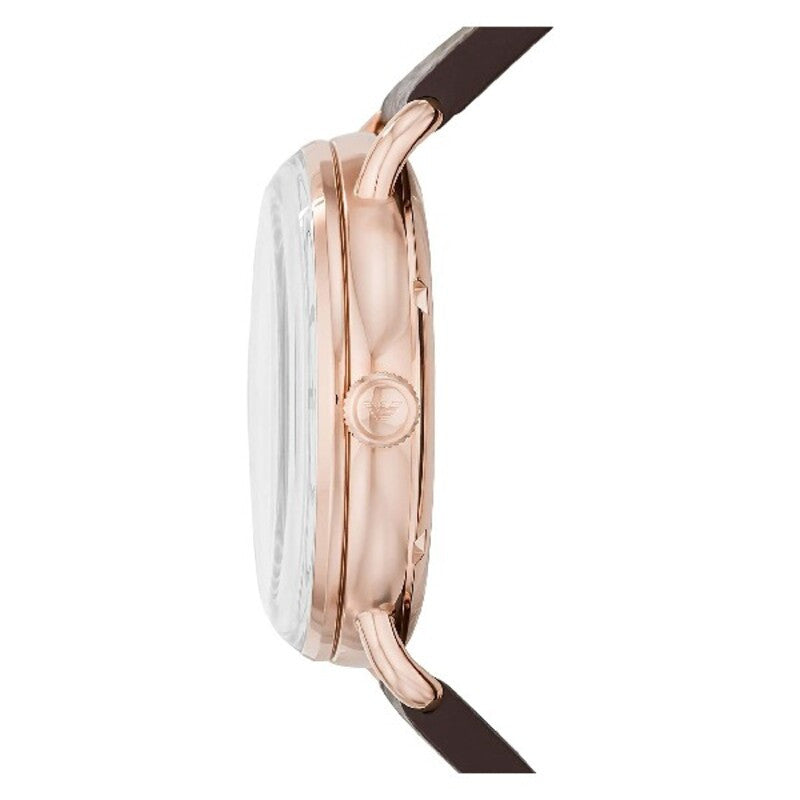 Side profile of rose gold watch case with brown leather strap