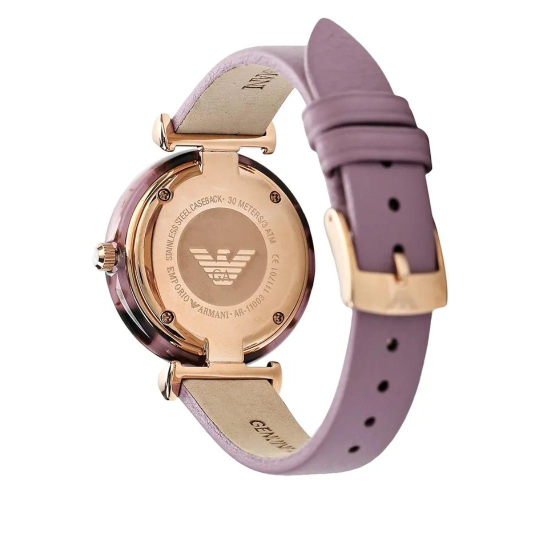 Case back of Emporio Armani Gianni watch showing engraved eagle logo and rose gold case with purple strap
