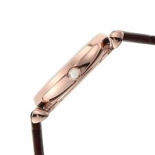 Side profile of rose gold watch case with dark brown leather strap and T-bar lugs