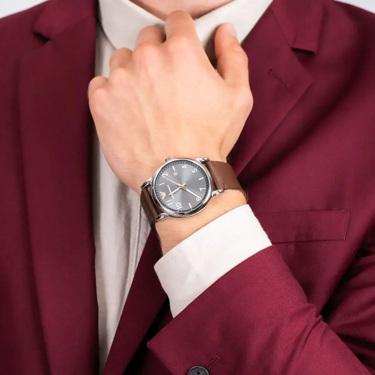 Emporio Armani Luigi watch worn on wrist with gray dial visible on brown leather strap