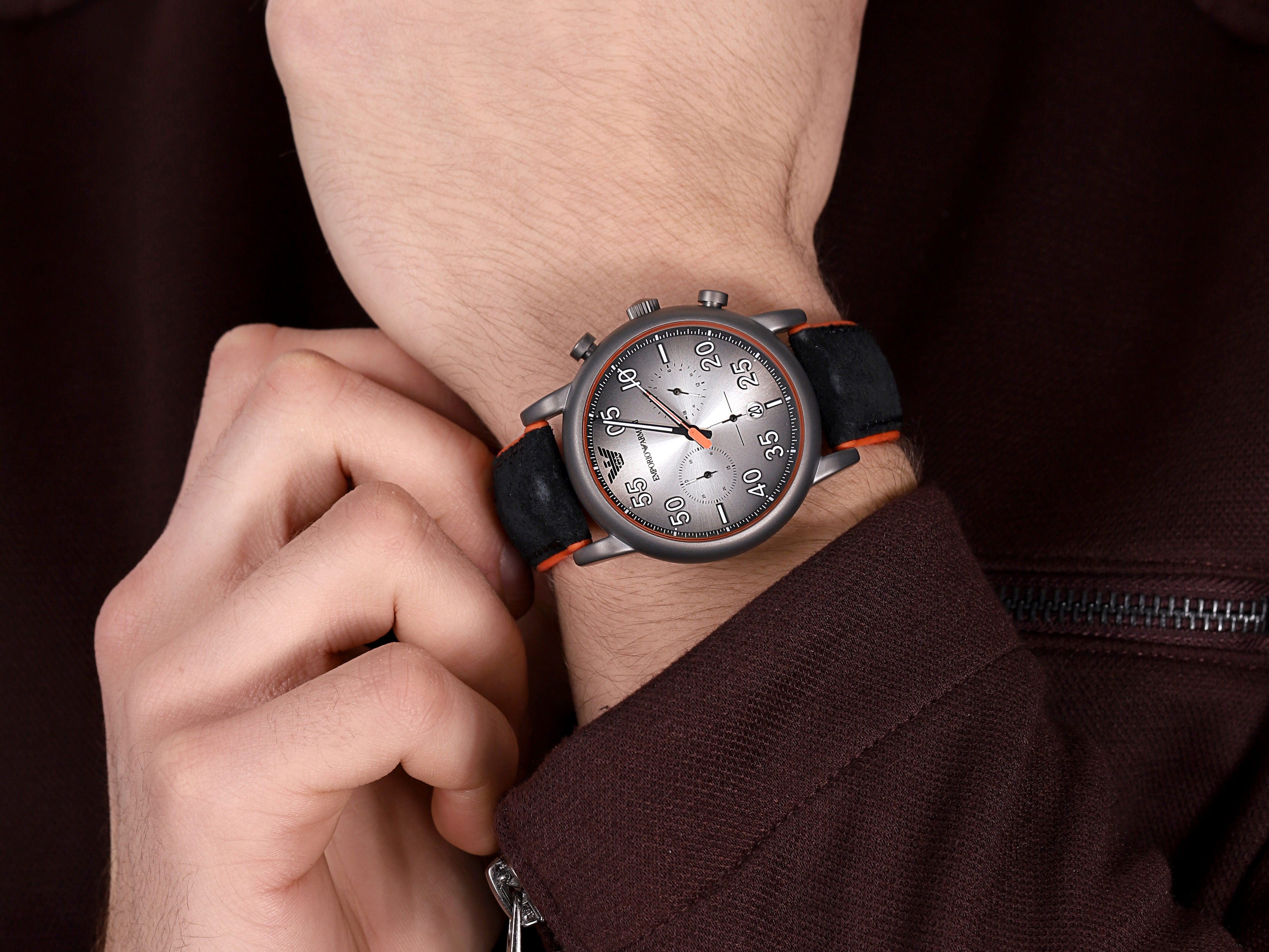 Emporio Armani AR11174 chronograph watch worn on wrist with gray dial and black orange strap visible