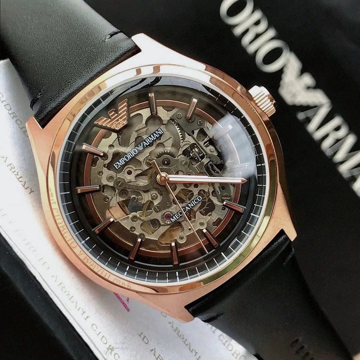 Emporio Armani rose gold skeleton watch on wrist with skeletonized dial visible