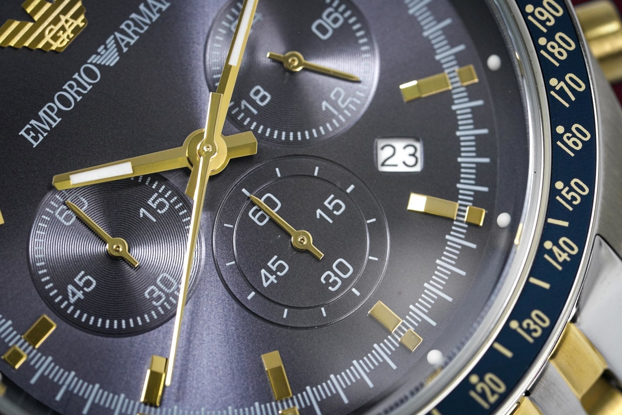 Emporio Armani Tazio AR8030 dial detail showing chronograph subdials, blue face, and gold hands