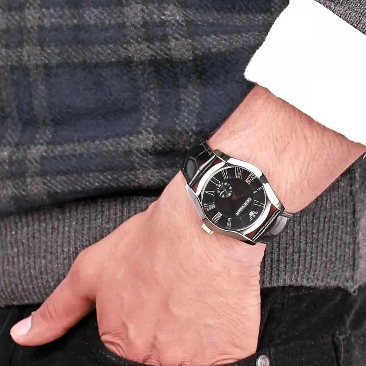Emporio Armani Valente AR0643 watch worn on wrist showing black dial and leather strap in use