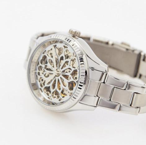 Fossil BQ3753 watch angled view showing skeleton dial and stainless steel bracelet